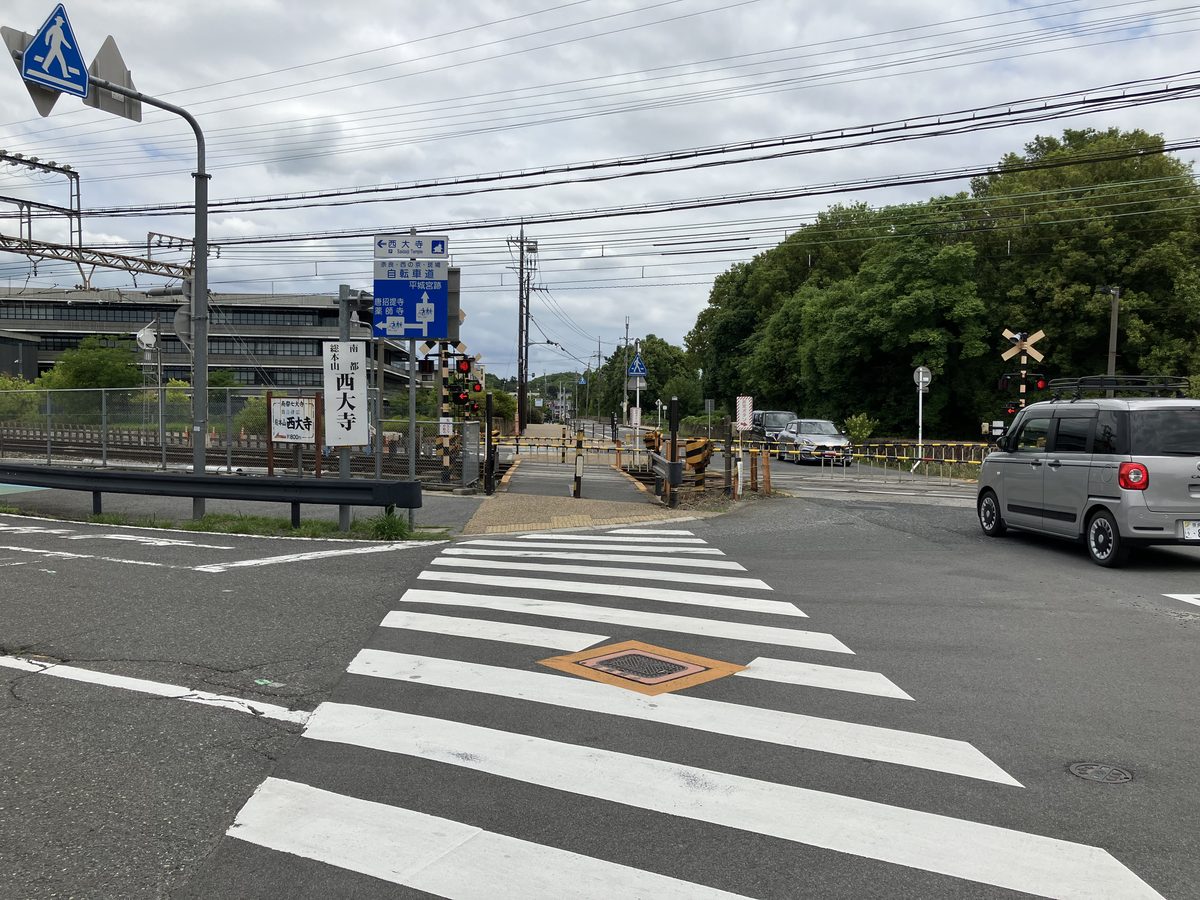 横断歩道を渡り踏切へ向かう